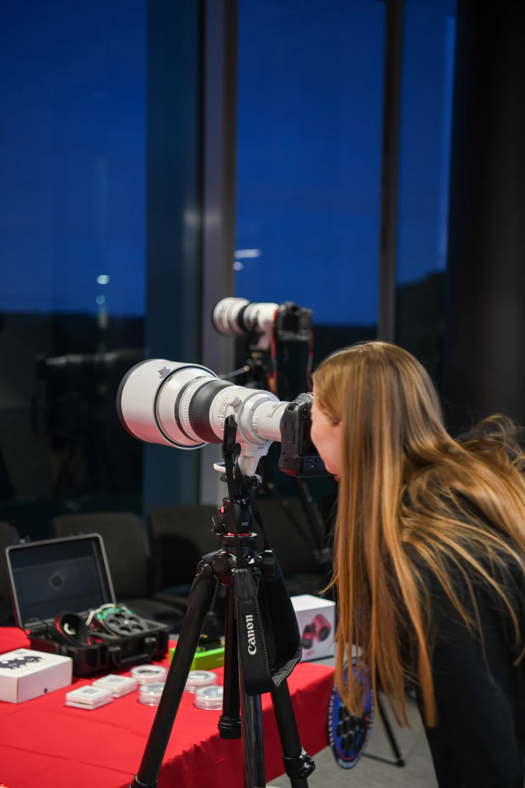 Photographer looking through long lens at the moon
