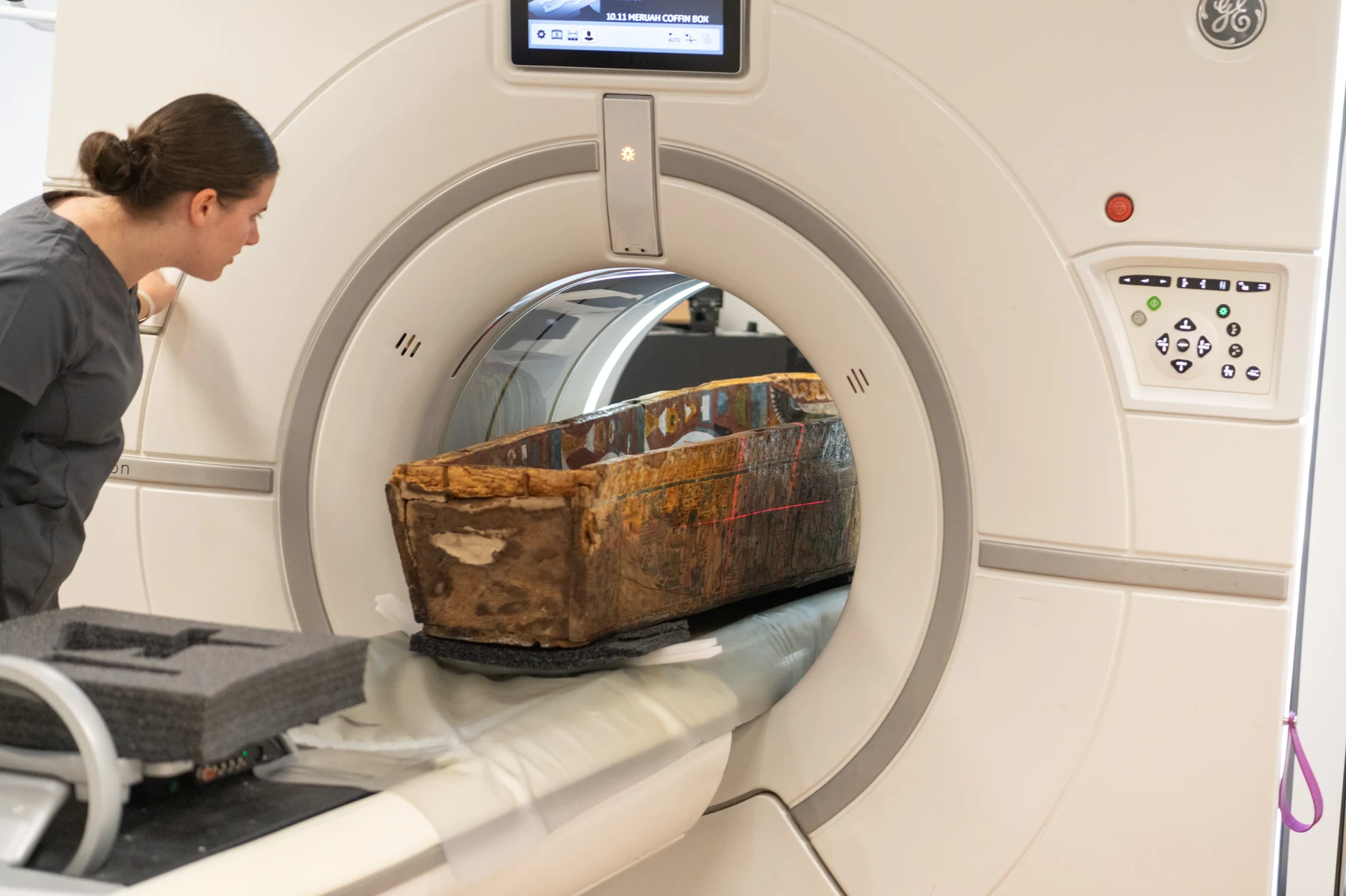 Painted coffin face with CT scanner laser alignment lines